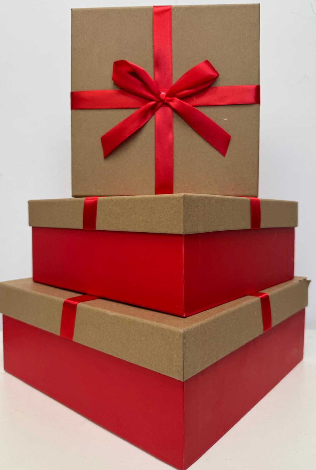 Stacked kraft and red gift boxes with ribbon