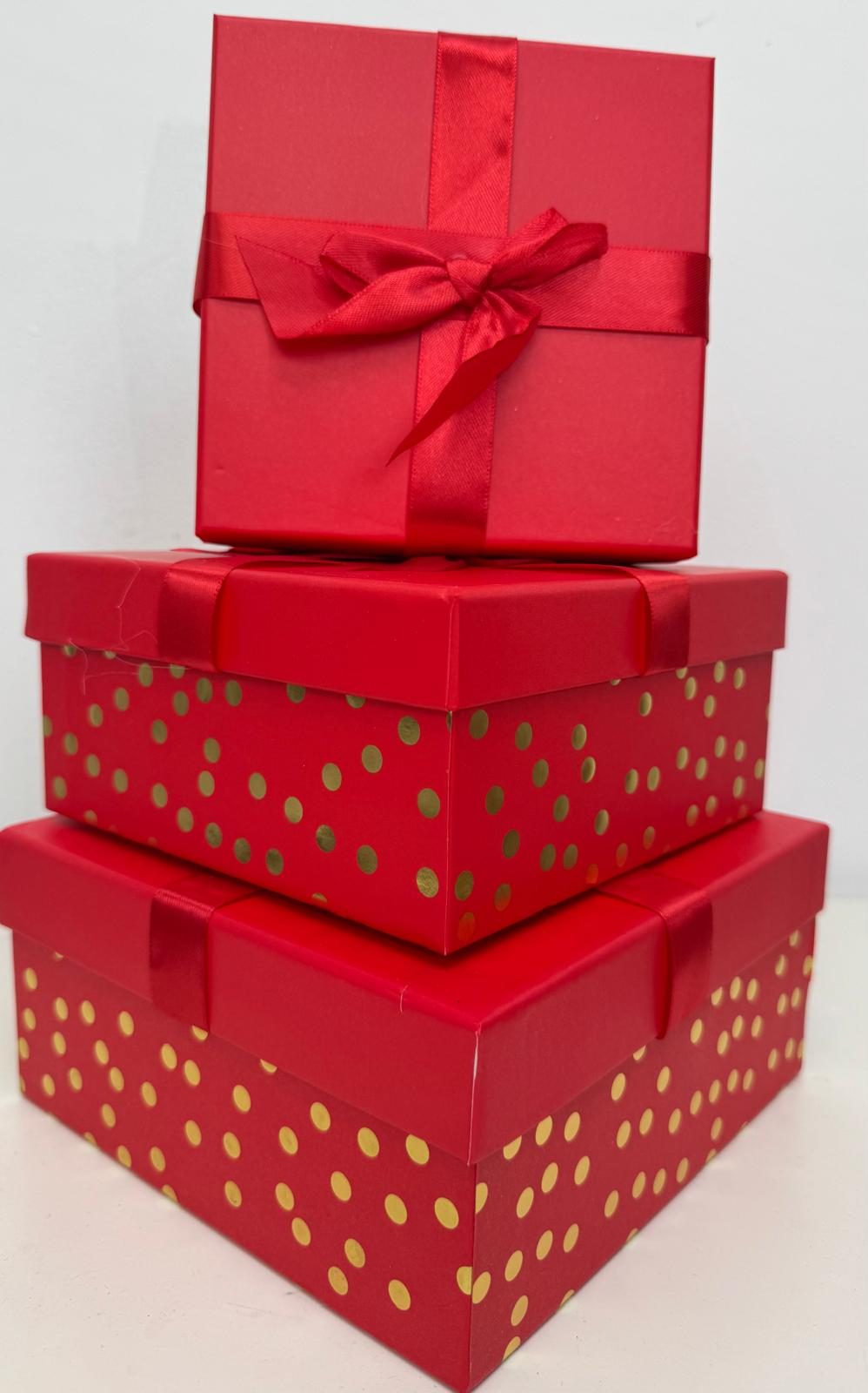 Stacked red and gold polka dot gift boxes